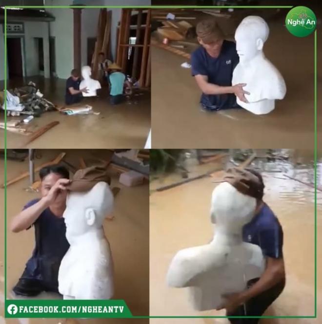 Khoảnh khắc xúc động người đàn ông che mũ cho tượng Bác trong mưa lũ 1