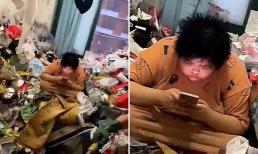 'Sốc' với hình ảnh cô gái sống giữa núi rác trong chung cư mà vẫn bình thản ngồi bấm điện thoại 