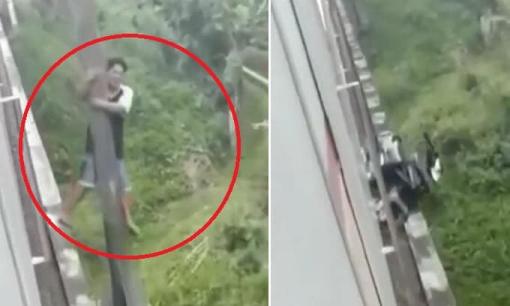 Đi tắt qua đường ray gặp đúng lúc tàu chạy, người đàn ông nhanh trí đu mình lên cột điện thoát chết trong gang tấc