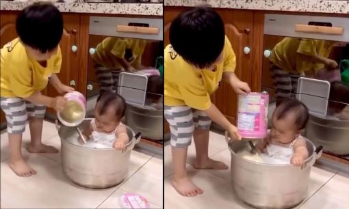 Chia sẻ cảnh con trai đổ sữa bột vào tắm cho em, phụ huynh bị cư dân mạng chỉ trích