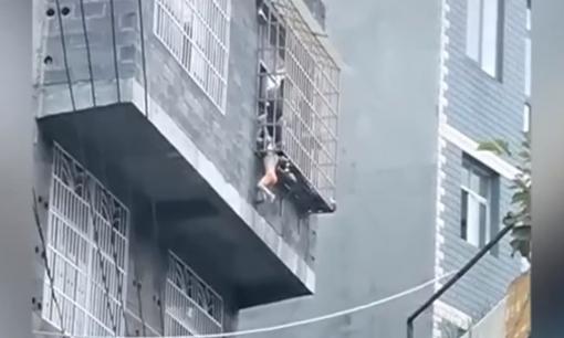 Bé gái kẹt cổ vào giữa 2 thanh chắn 'chuồng cọp' chung cư, treo lơ lửng bên ngoài cửa sổ tầng 3