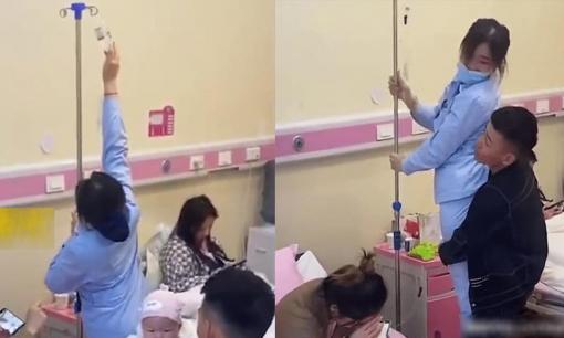 Nữ y tá không treo được truyền dịch, người vợ bảo chồng giúp nhưng hành động sau đó của anh chồng gây tranh cãi dữ dội